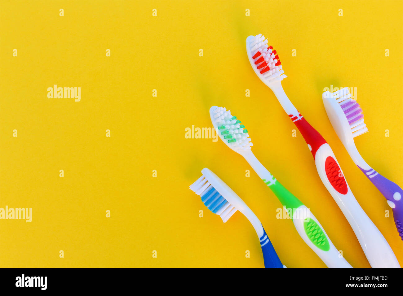 Toothbrushes on yellow background. Top view Stock Photo - Alamy