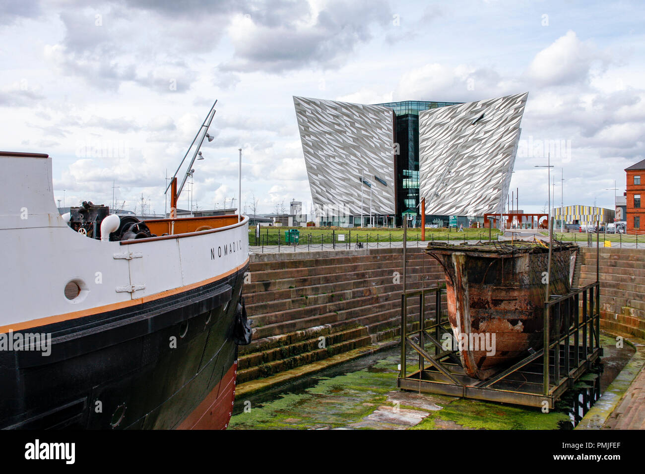 SS Nomadic, the last remaining ship of the White Star Line and the Titanic Belfast museum in the Titanic Quarter of Belfast, Northern Ireland. Stock Photo