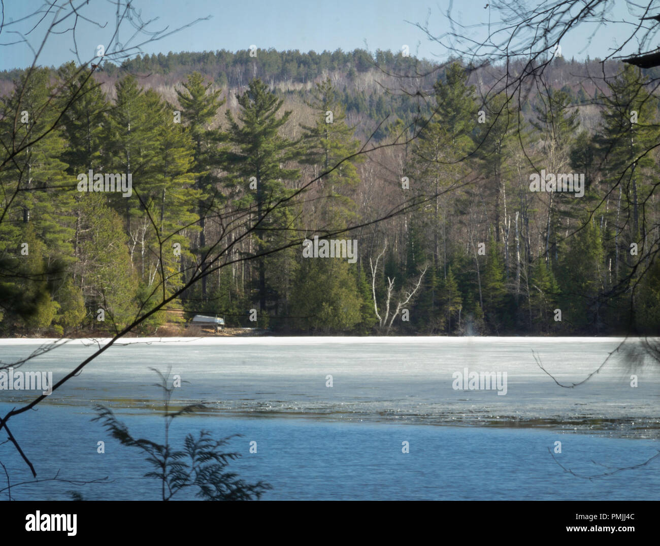 Spring thaw in Renfrew Valley, Canada, with ice melting on a small lake Stock Photo