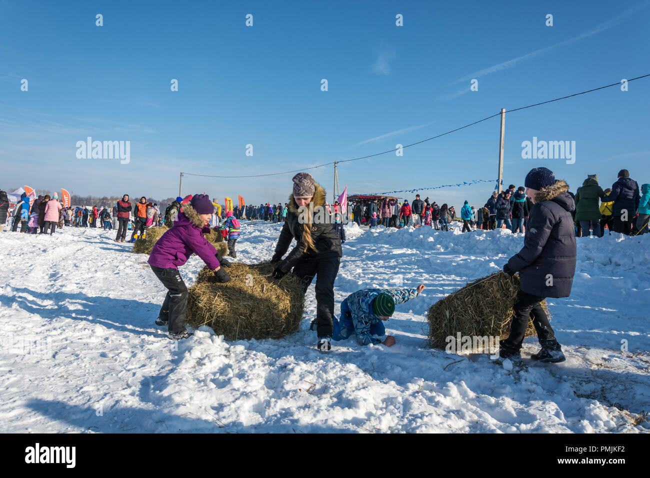 City of Uglich, Yaroslavl region, Russia - 10.02.2018: Merry competition for hay carrying at the festival Winter fun in Uglich, 10.02.2018 in Uglich,  Stock Photo