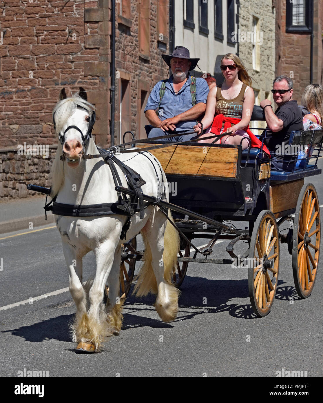 Gypsy Travellers riding on carriage. Appleby Horse Fair 2018. The Sands, Appleby-in-Westmorland, Cumbria, England, United Kingdom, Europe. Stock Photo