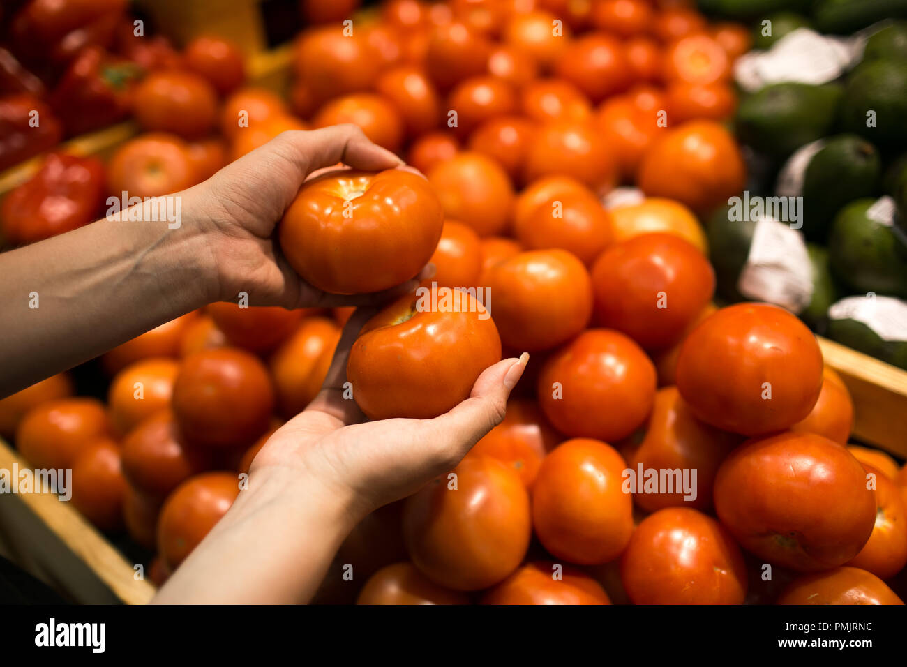 Red ripe juicy tomatoes in women's hands in market Stock Photo - Alamy