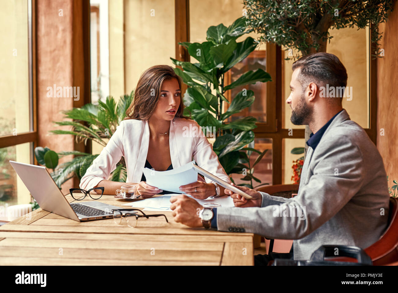 Business lunch. Business people sitting at table at restaurant looking at each other discussing project concentrated Stock Photo
