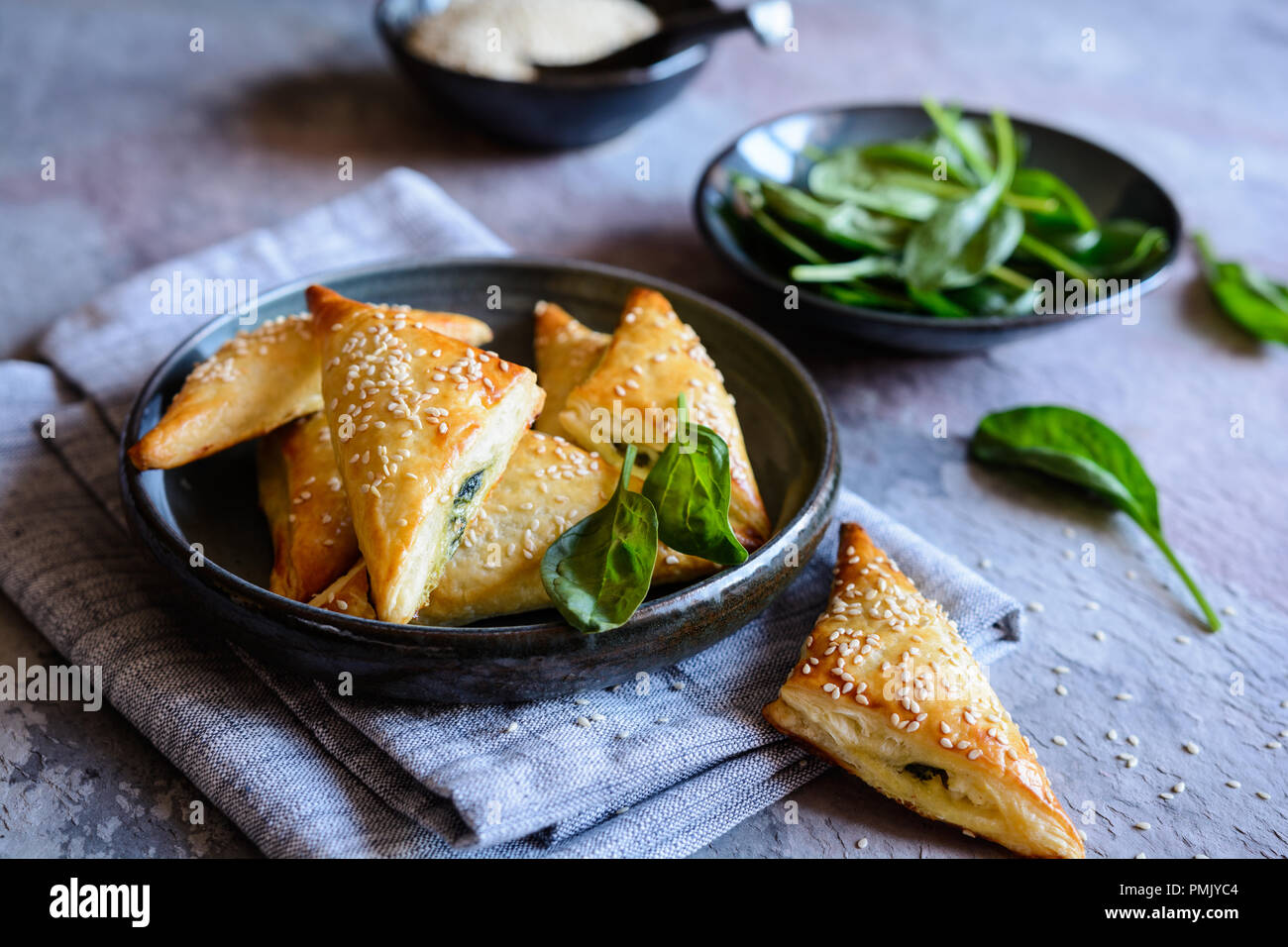 Freshly baked Spanakopita triangles stuffed with spinach and Feta cheese Stock Photo