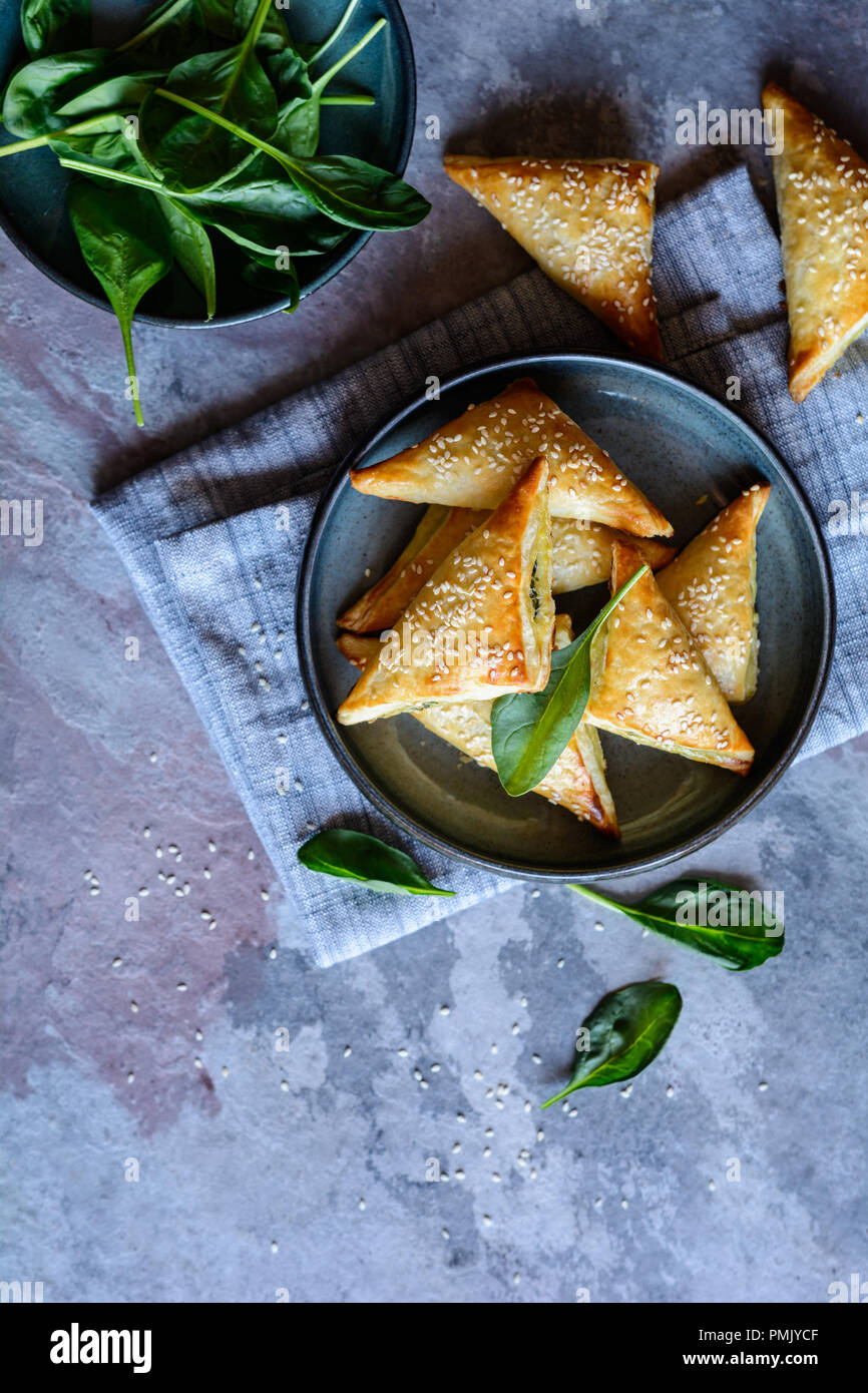 Freshly baked Spanakopita triangles stuffed with spinach and Feta cheese Stock Photo