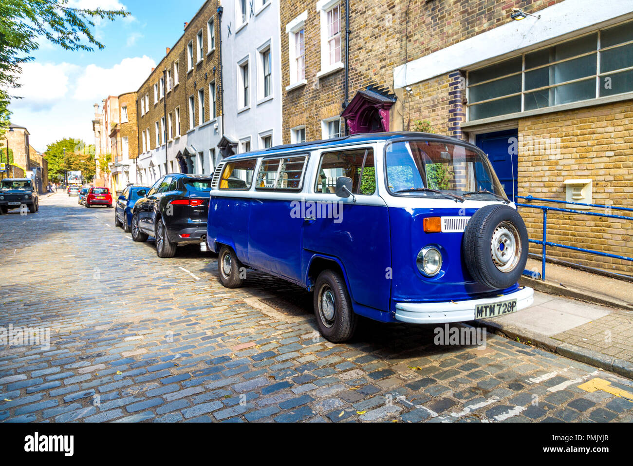 Dark blue vintage Volkswagen Bus T2 parked on a cobbled street, London, UK Stock Photo