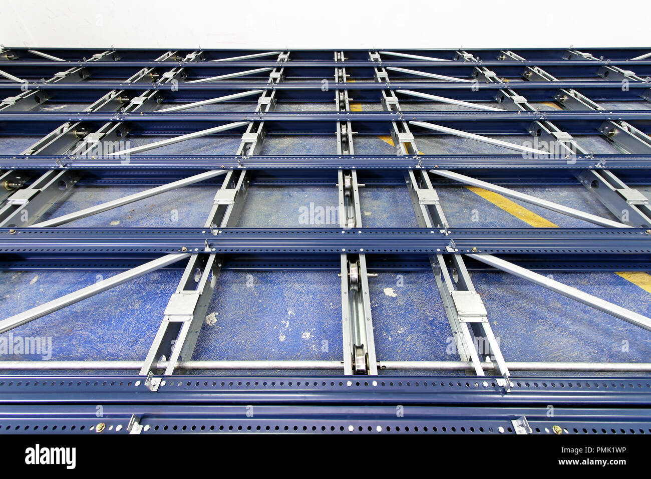 Metal base and rollers for automated shelving system Stock Photo Alamy