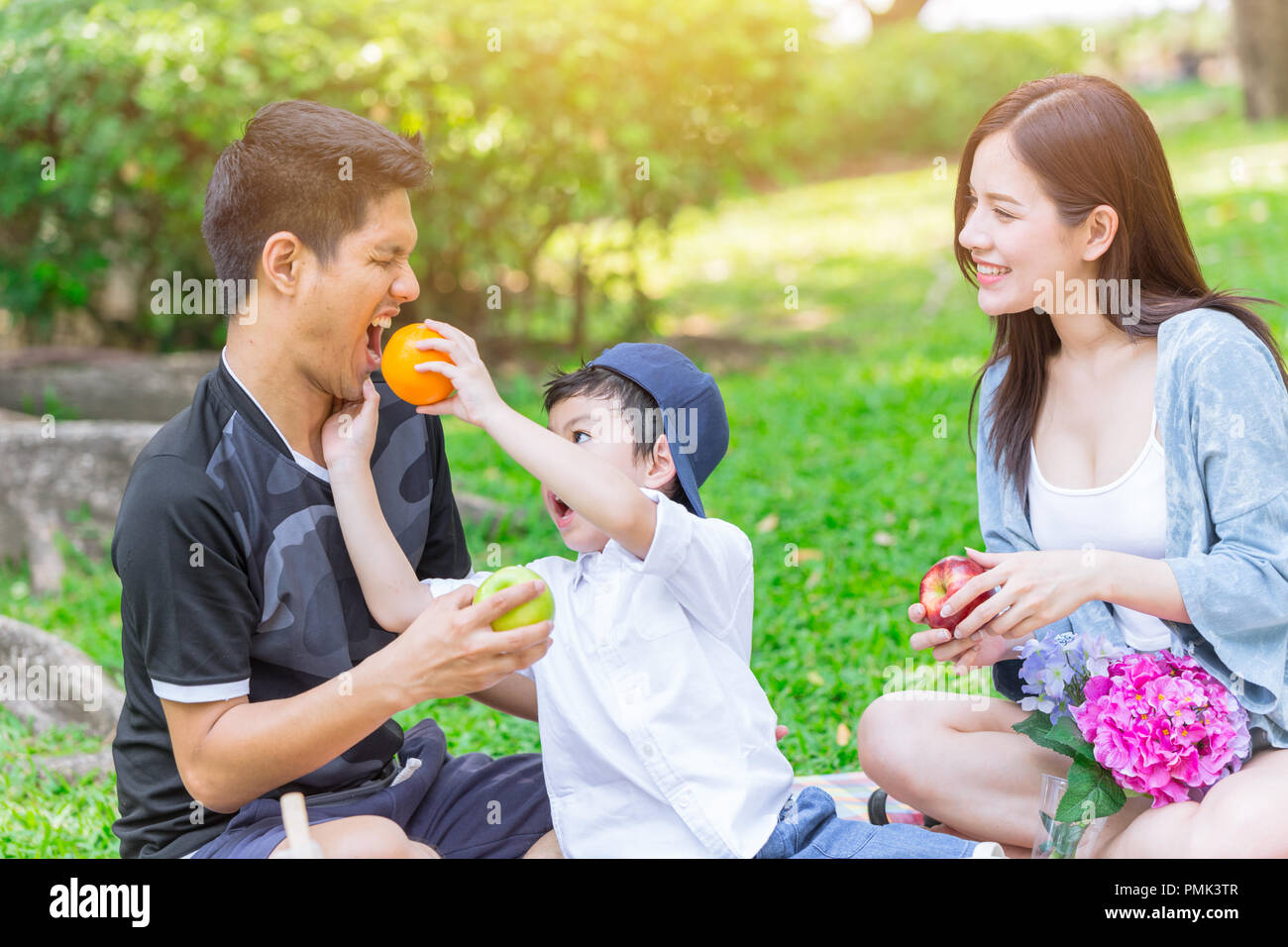 Asian teen family happy holiday picnic moment in the park Stock Photo