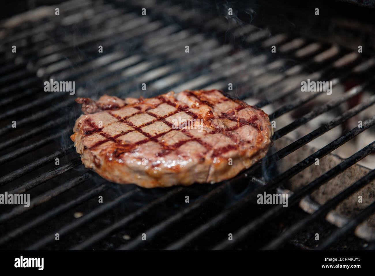 Beef Loin Top Sirloin Steak Cooking on the Grill at restourant Stock