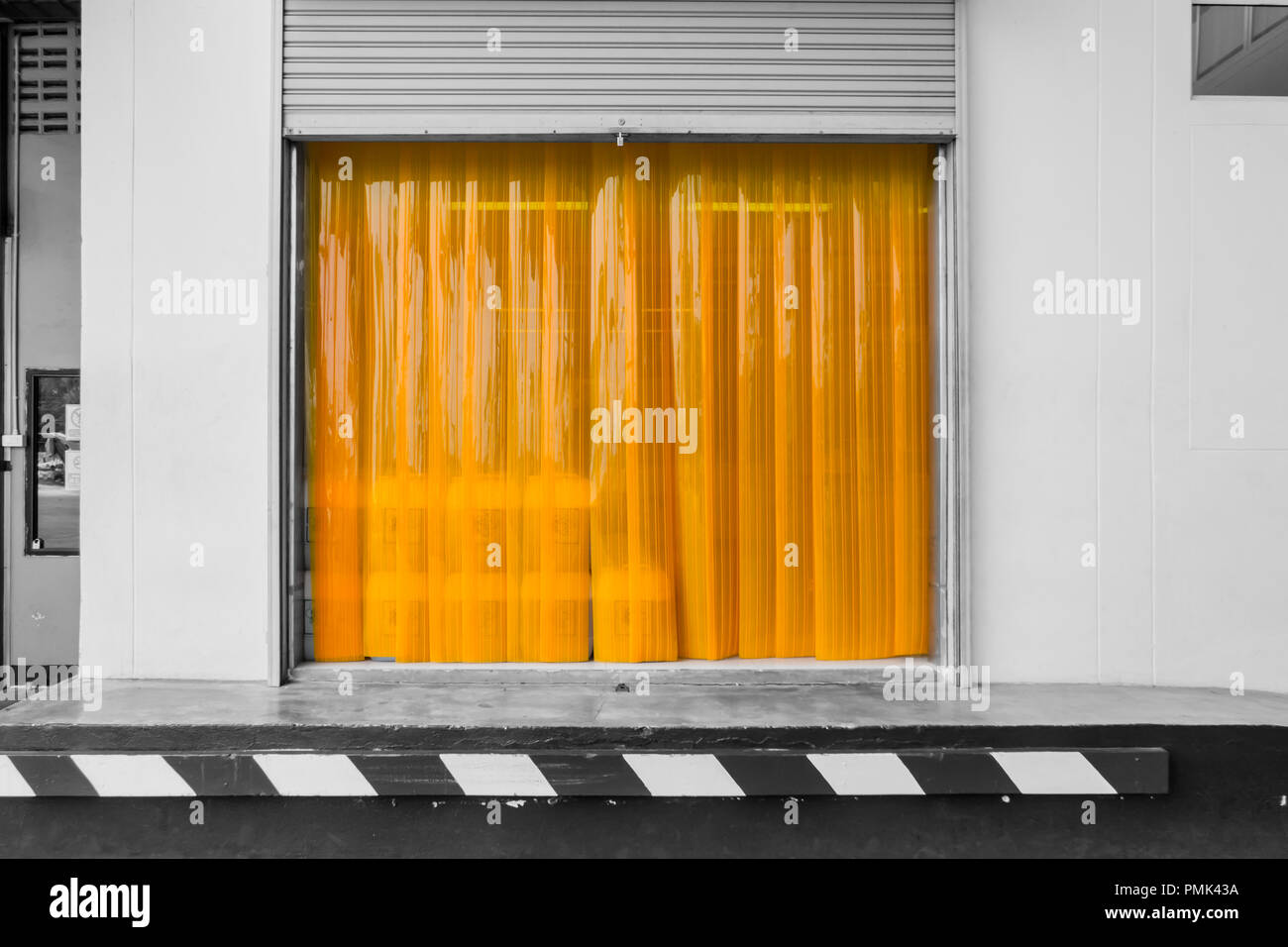 Warehouse gate loading area with PVC strip curtain or plastic strip doors. Stock Photo