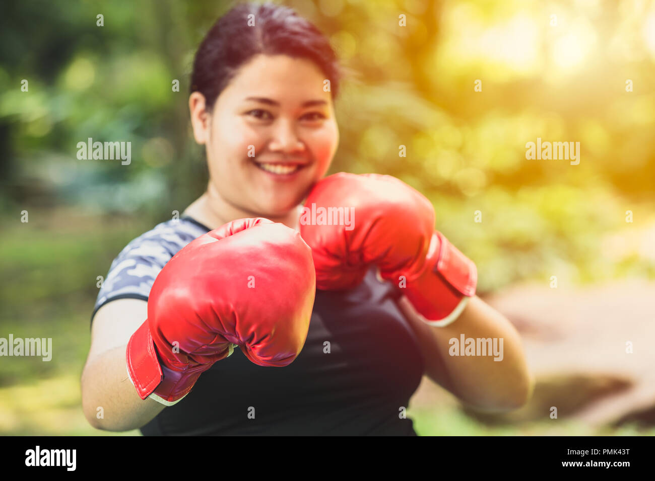 Big girl fatty Asian woman boxing fighter with fat and diet concept Stock Photo