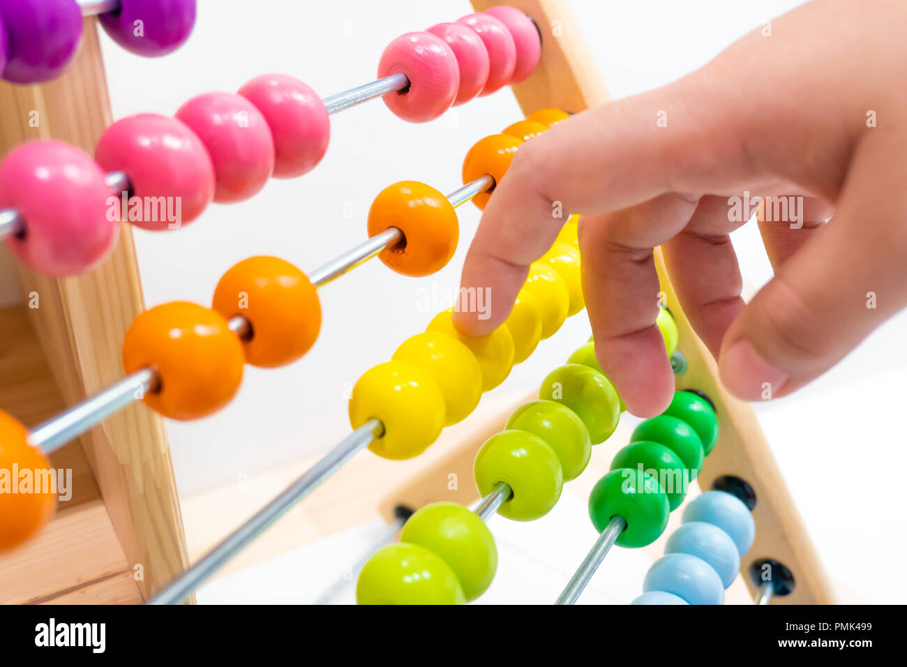 colorful abacus children toy hand playing for practice math and calculation learning for kids. Stock Photo