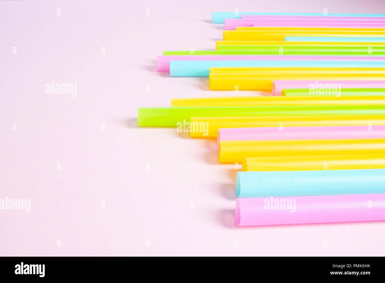 Plastic Drinking Straws on Pink Background Stock Photo