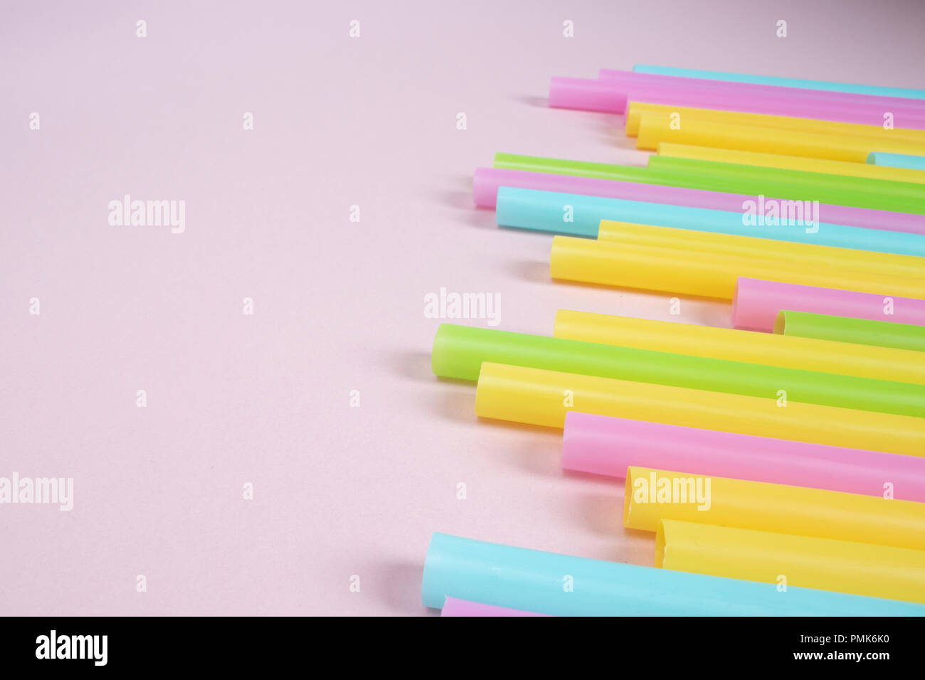 Plastic Drinking Straws on Pink Background Stock Photo