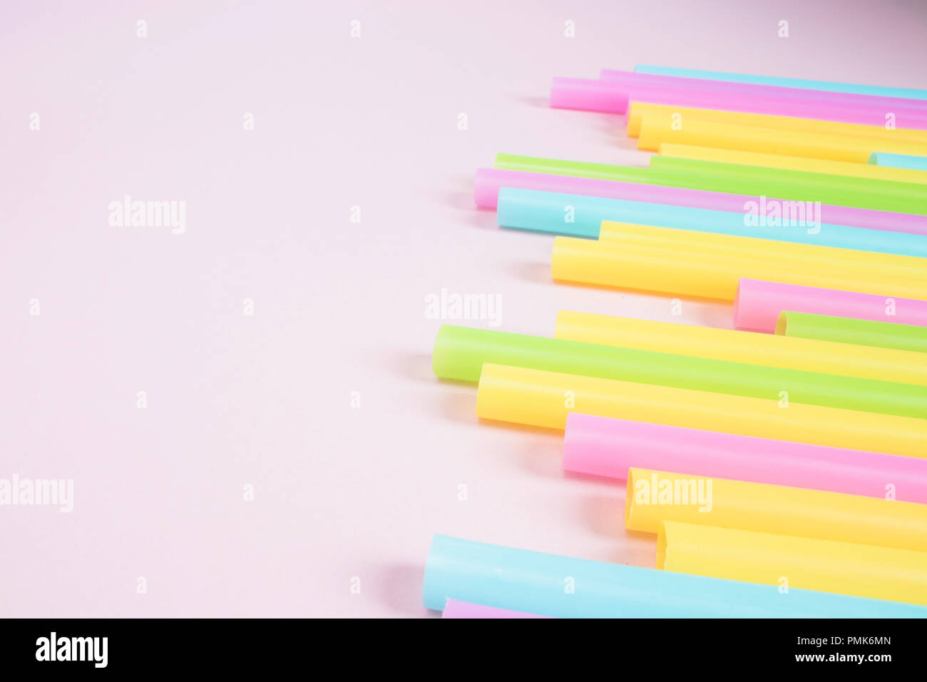 Plastic Drinking Straws on Pink Background Stock Photo