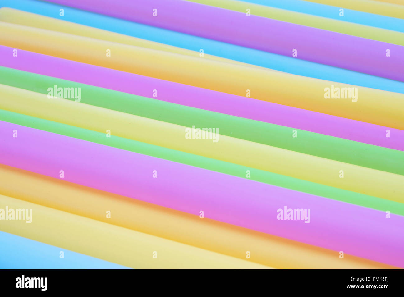Multiple brightly coloured plastic straws - macro Stock Photo