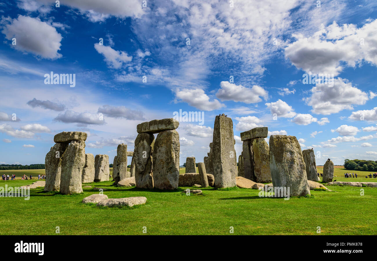 Stonehenge, against a bright blue sky with light clouds Stock Photo