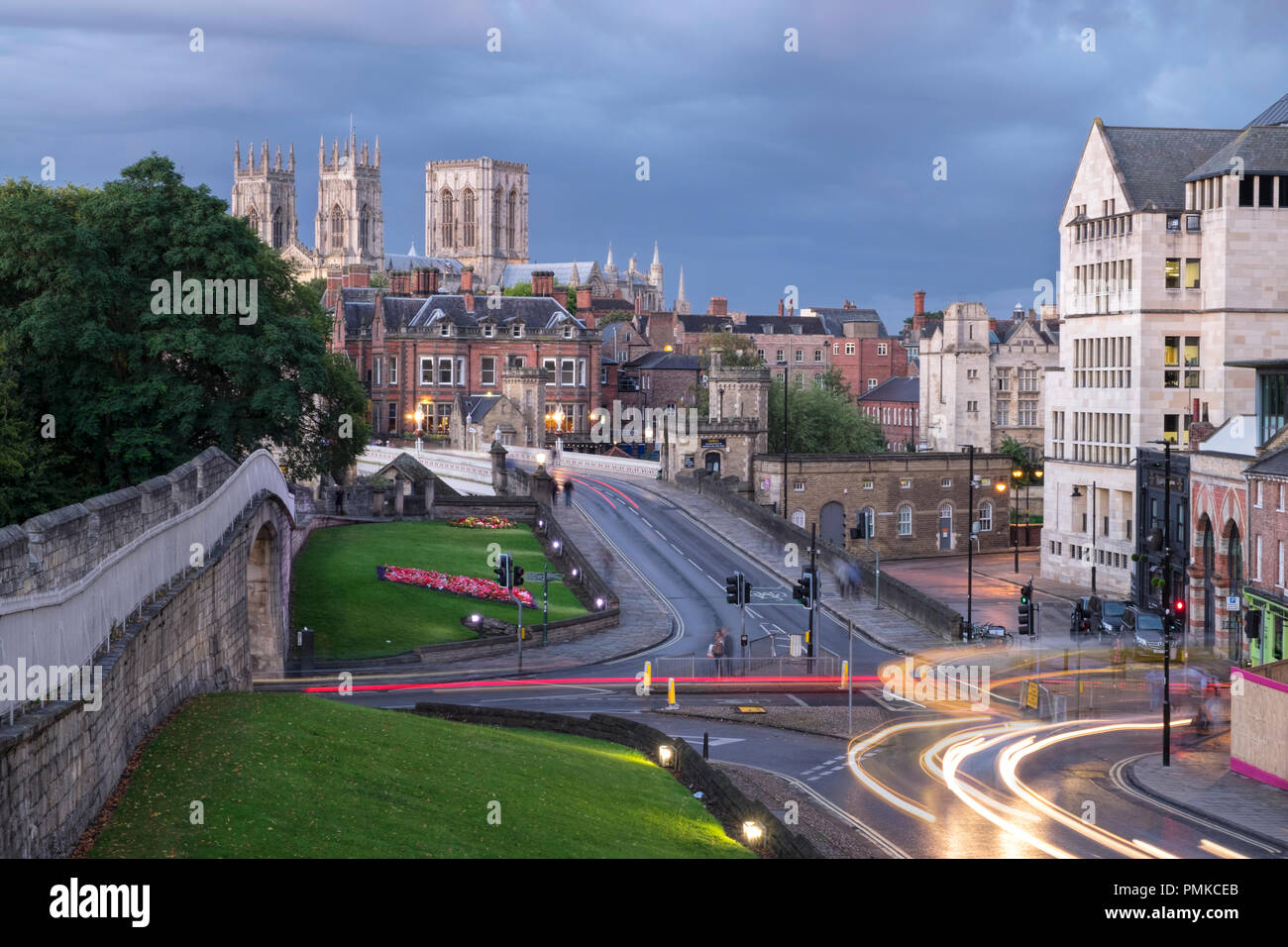 York Minster from the City Walls, evening with light trials from passing vehicles. Stock Photo