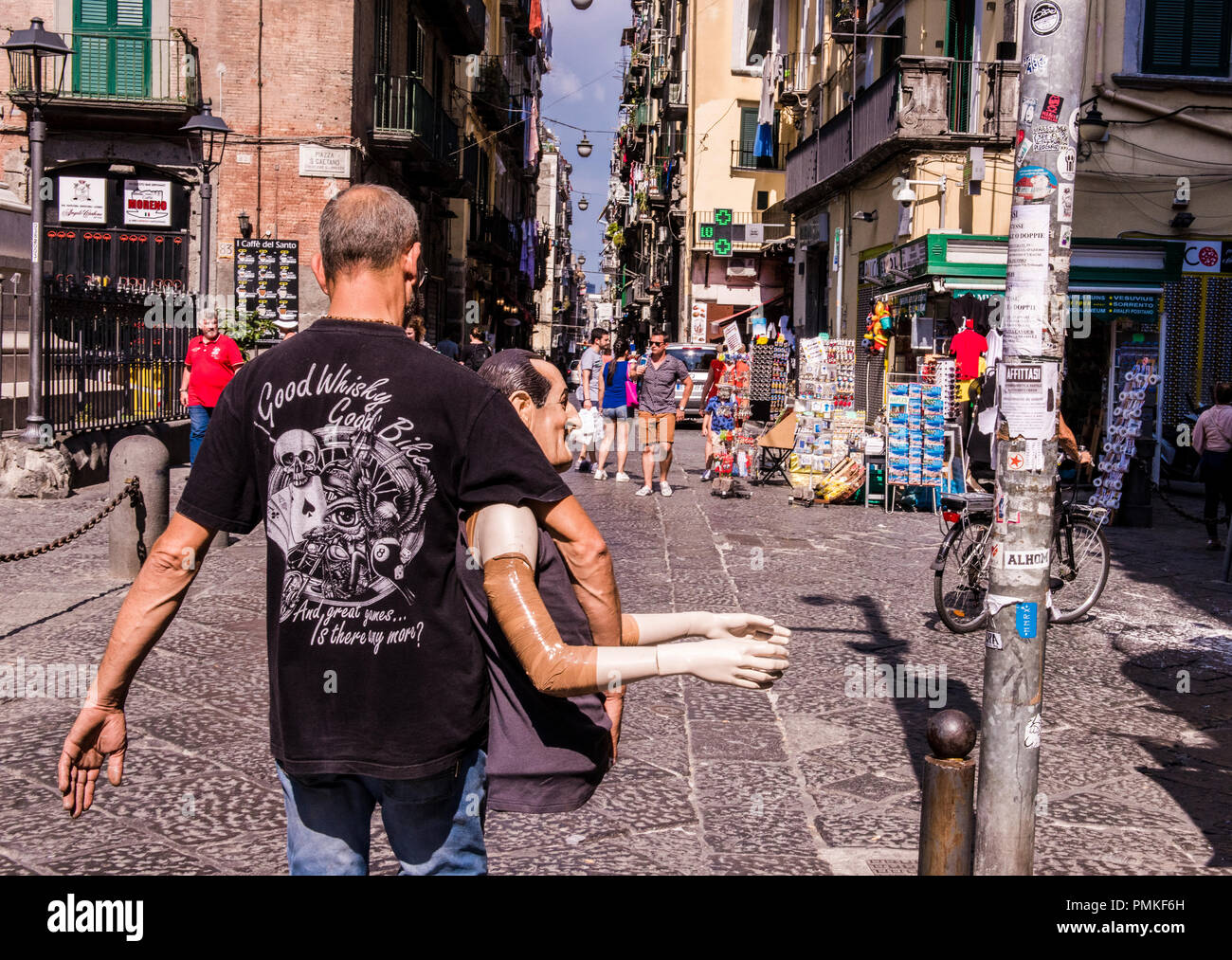 Rear view of man walking through street, carrying dummy of famous Italian actor Antonio De Curtis, better known as Toto, Naples, Italy, Europe Stock Photo