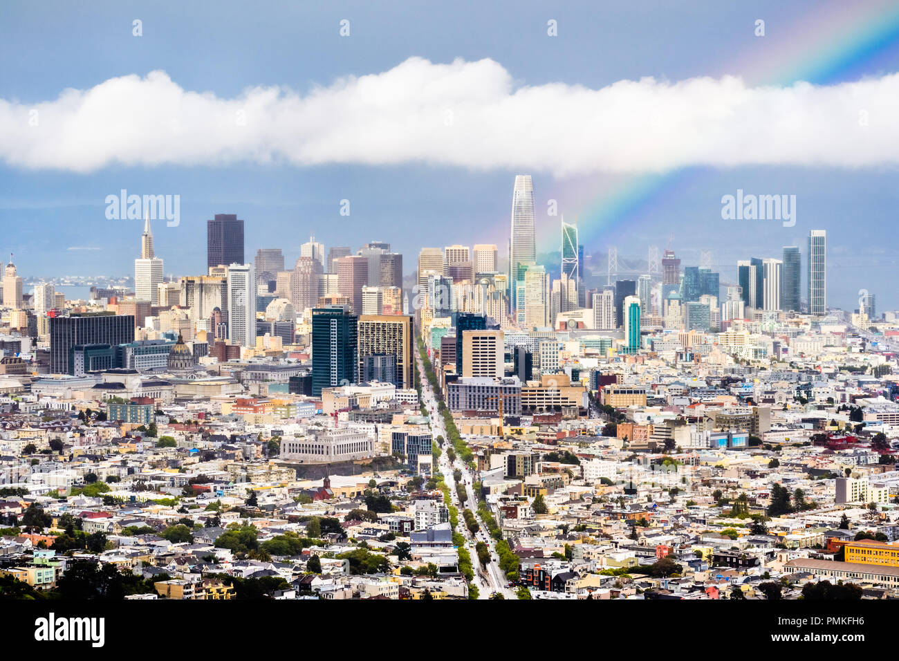Aerial view of San Francisco's financial district skyline on a rainy day, bright rainbow rising from downtown; Stock Photo