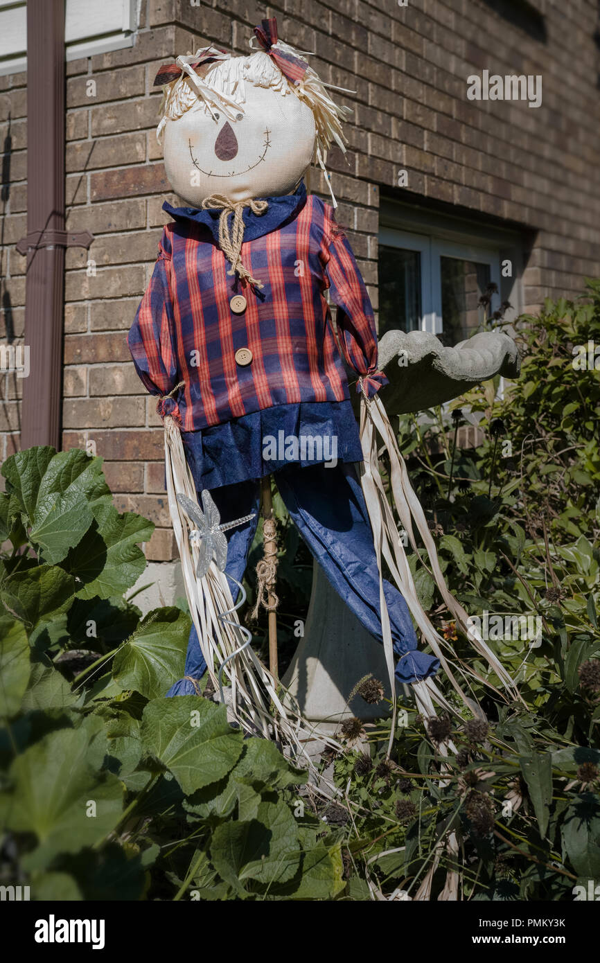 Halloween, outside decorations, straw man, scarecrow in front of the house. Stock Photo