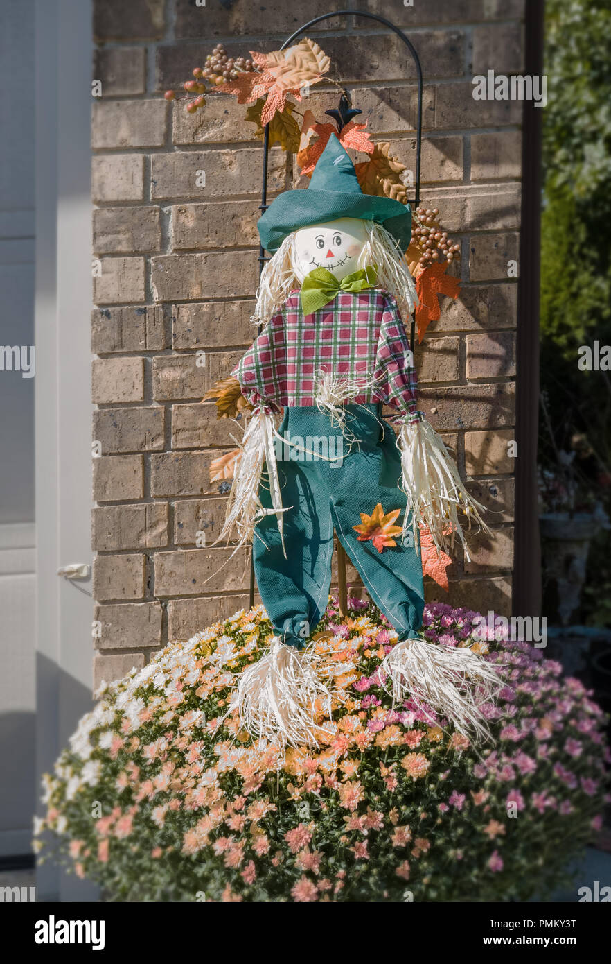 Halloween, outside decorations, straw man, scarecrow in front of the house. Stock Photo