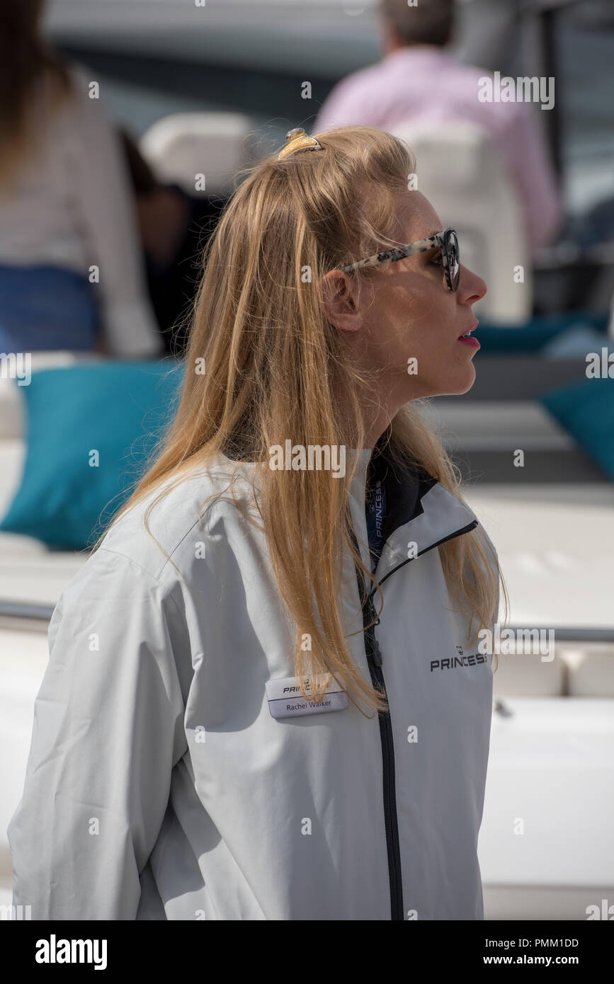 fashionable, sophisticated and attractive young lady working at the Southampton international boat show. Stock Photo