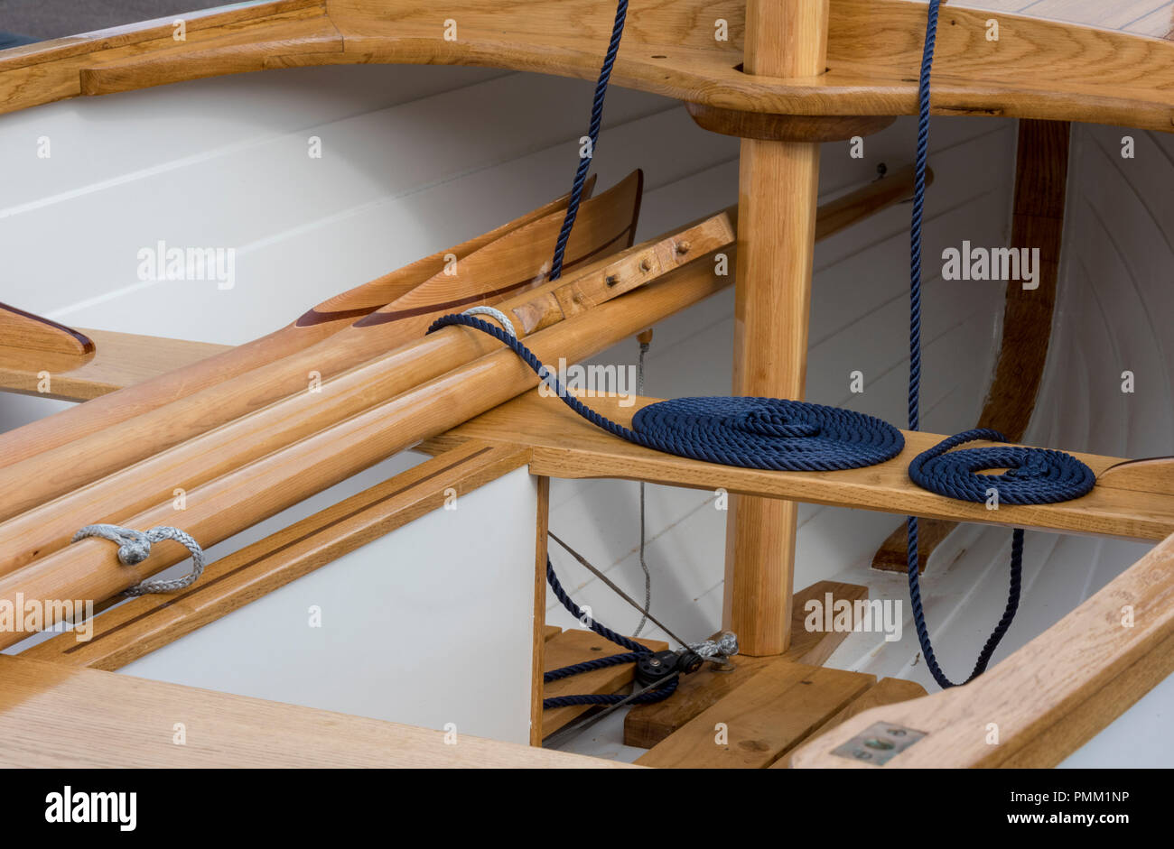 wooden boat thwarts, oars and ropes with a wooden mast in a