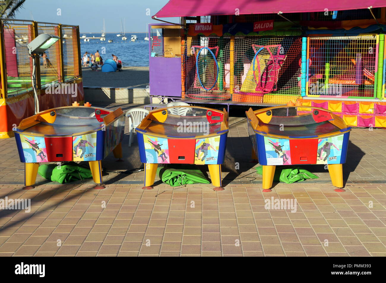 Santiago de la Ribera, Spain - July 31 2018: Colorful air hockey games on the promenade near the sea in this popular Spanish coastal tourist resort in Stock Photo