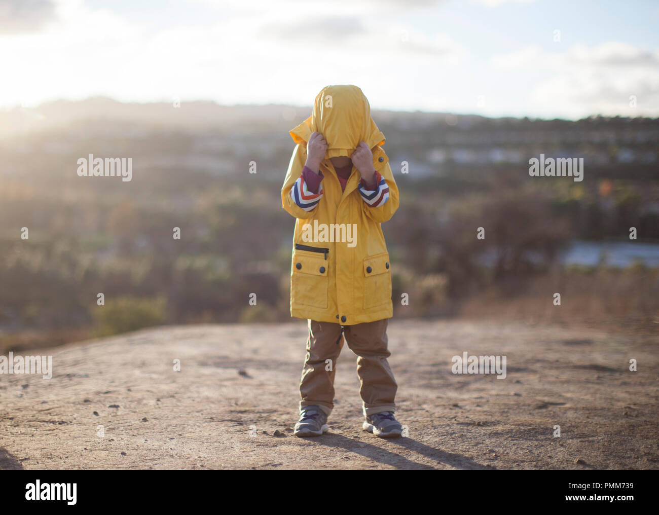 Boy pulling a hood over his face, Orange County, California, United States Stock Photo
