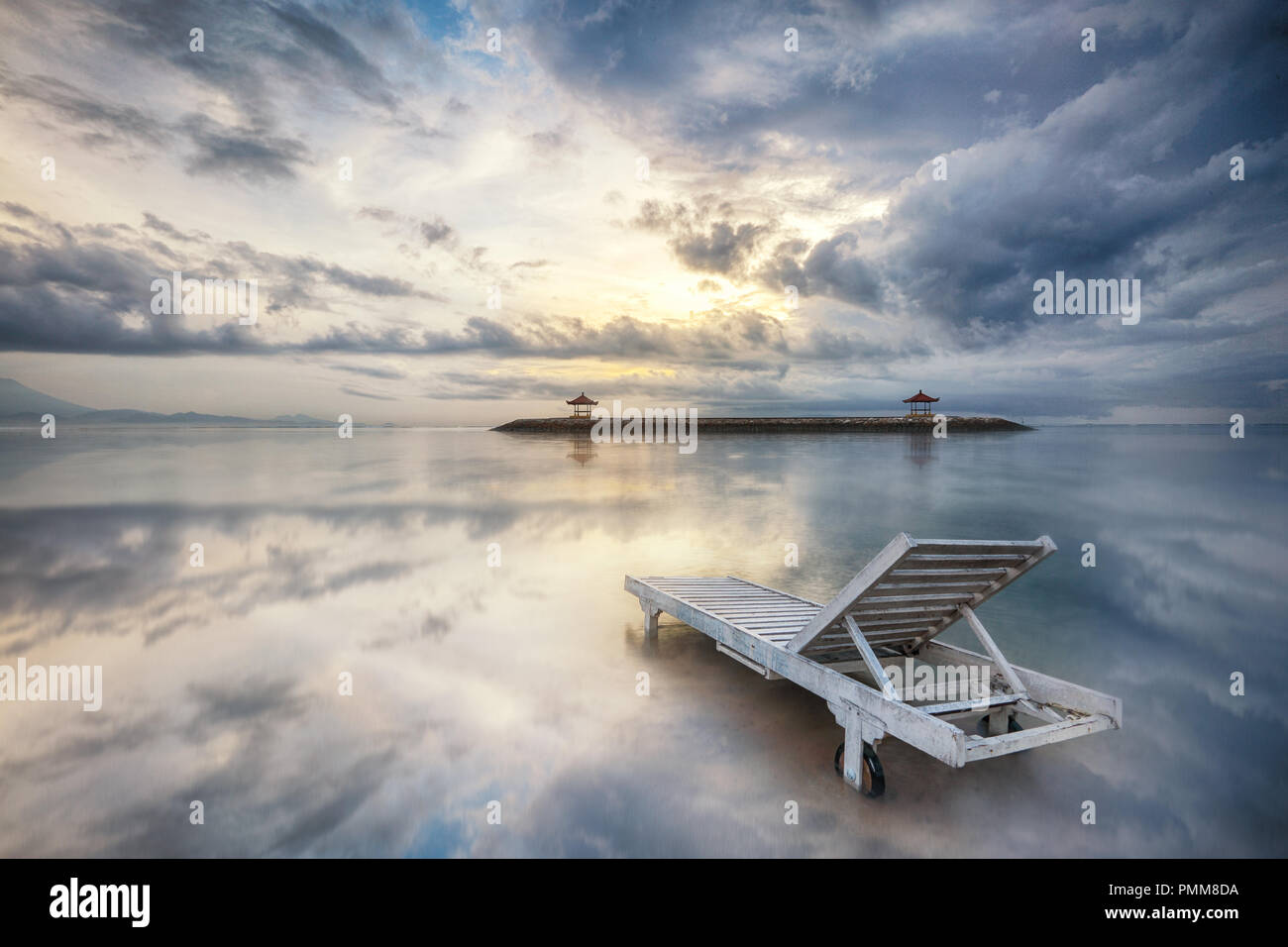 Sunlounger on a beach at sunset, Bali, Indonesia Stock Photo