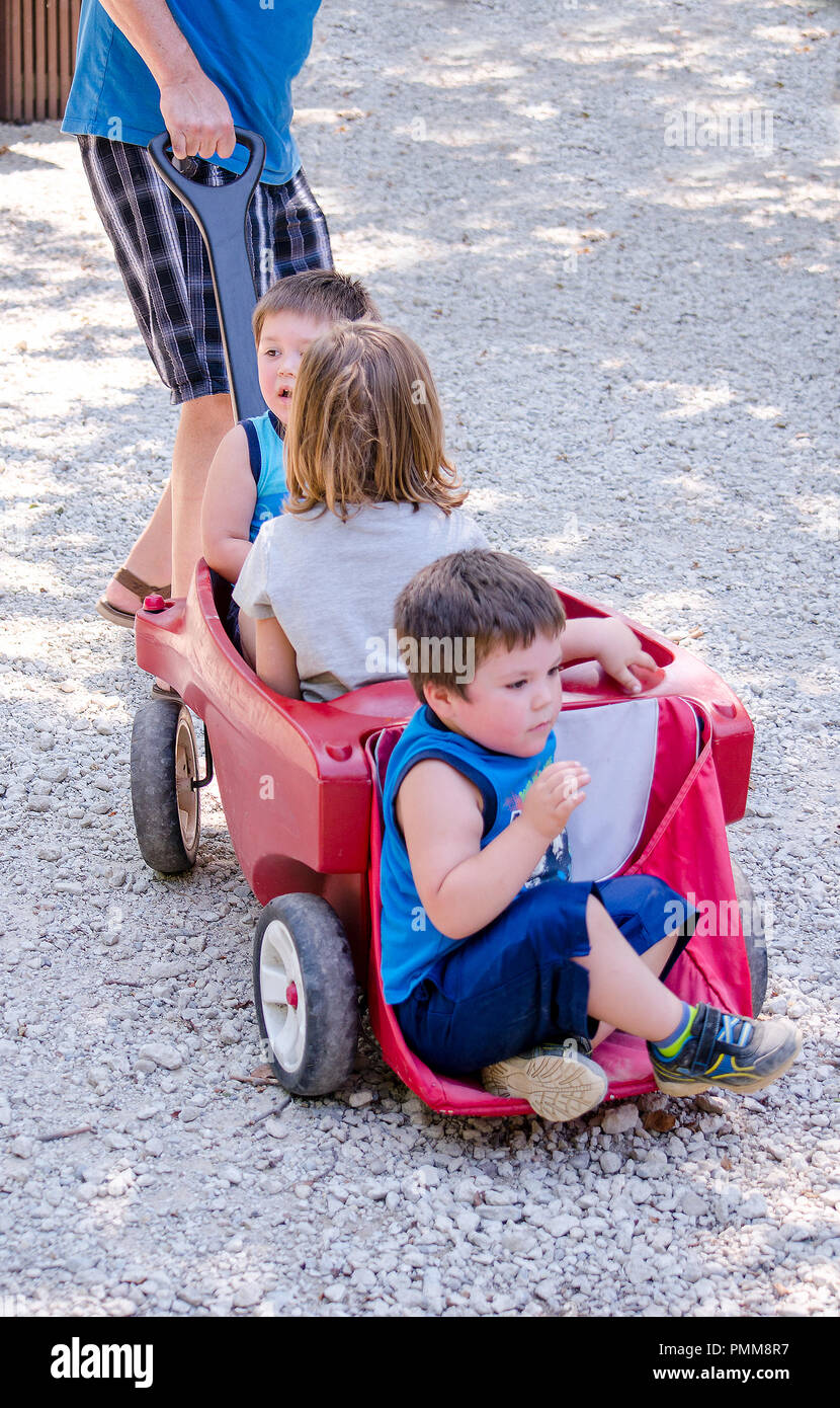 kids in a wagon being pulled Stock Photo