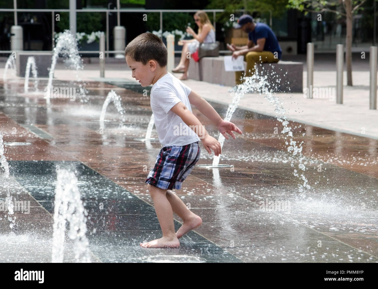 summer splashing in an outdoor urban splash pad Stock Photo Alamy