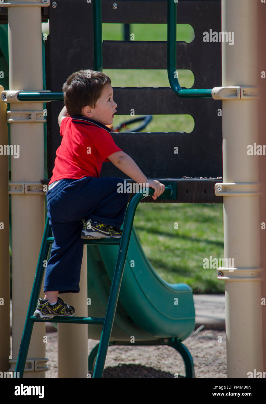 little toddler climbing up stairs on a slide Stock Photo Alamy