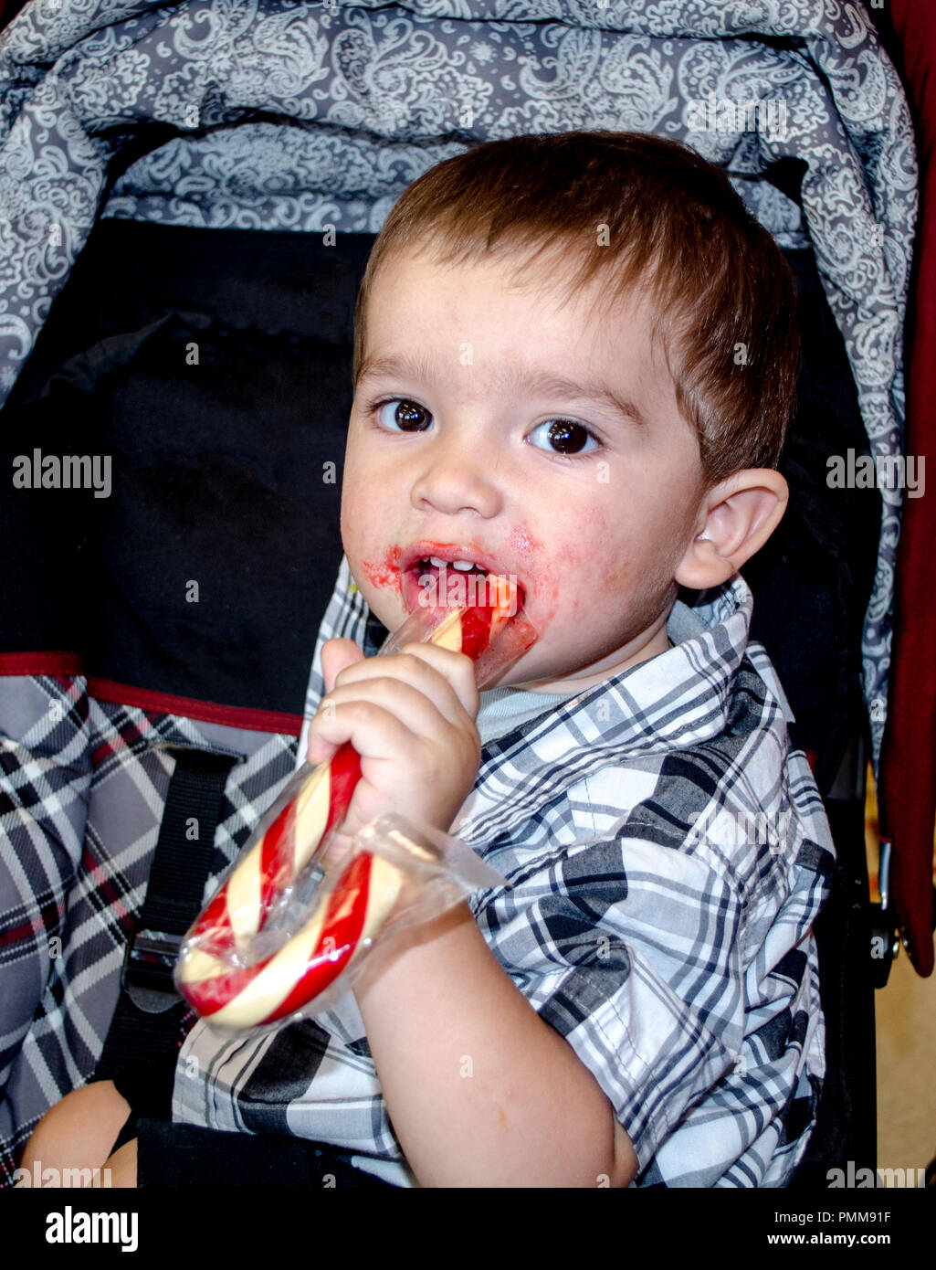 Toddler with sweet candy cane Stock Photo