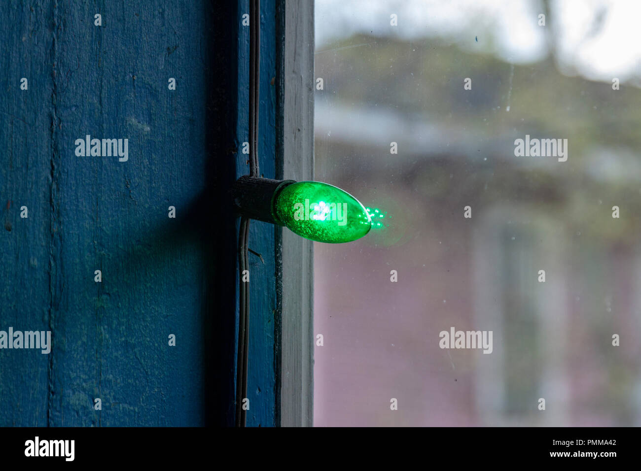 Green light decoration in a window near the St. Patrick’s Day parade on Magazine Street in New Orleans, Louisiana Stock Photo