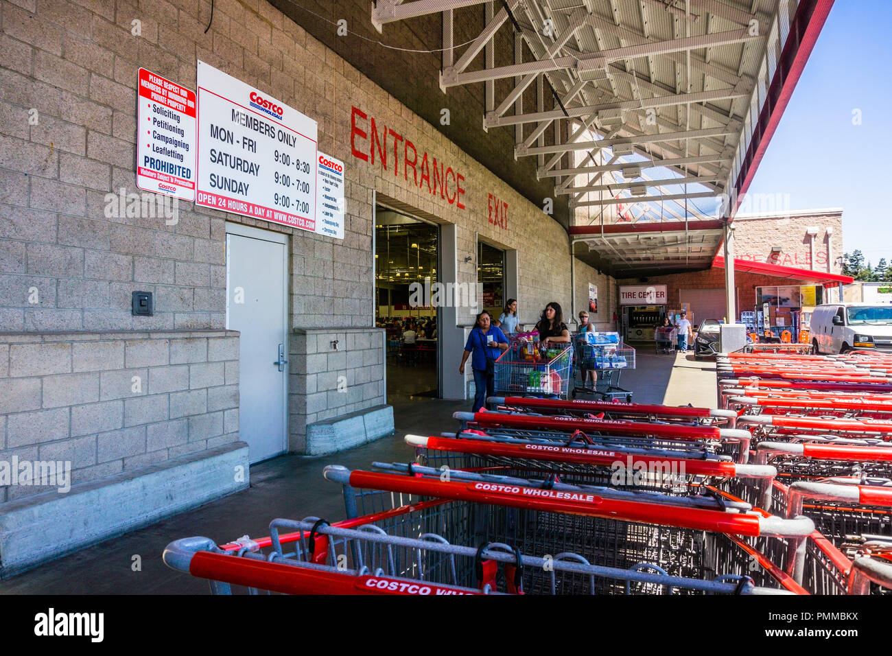 August 6, 2018 Mountain View / CA / USA - Entrance to one of the Costco Wholesale shop in south San Francisco bay; stores hours displayed on the wall Stock Photo