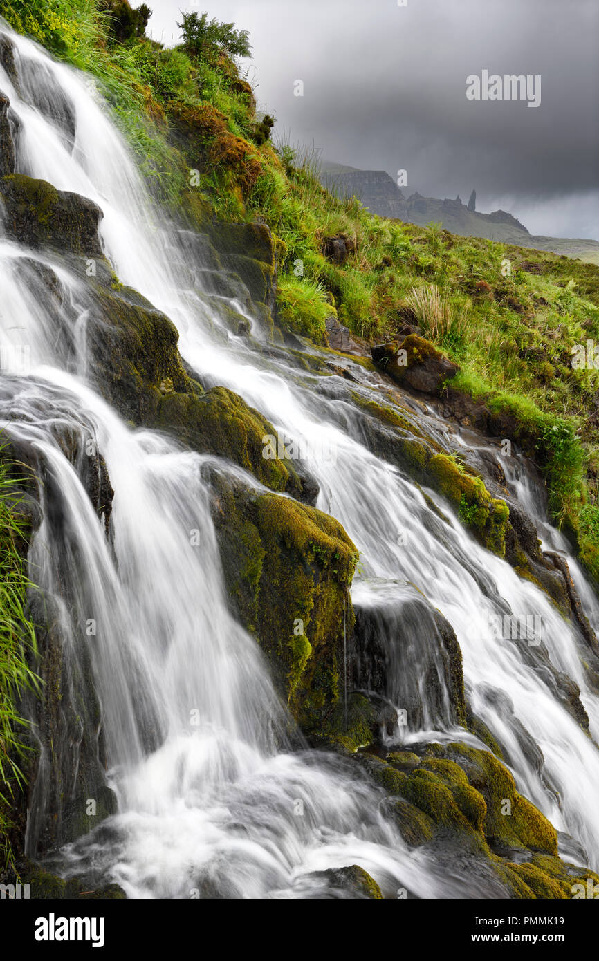 Flowing Bride's Veil WaterFalls to Loch Leathan at The Storr with Old Man of Storr peak in clouds on Isle of Skye Inner Hebrides Scotland UK Stock Photo