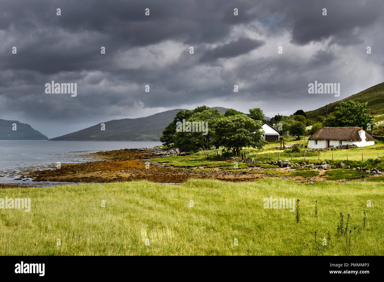 Katie Ann's Thatched Cottage at Luib on Isle of Skye with Loch Ainort Inner Hebrides Scottish Highlands Scotland UK Stock Photo