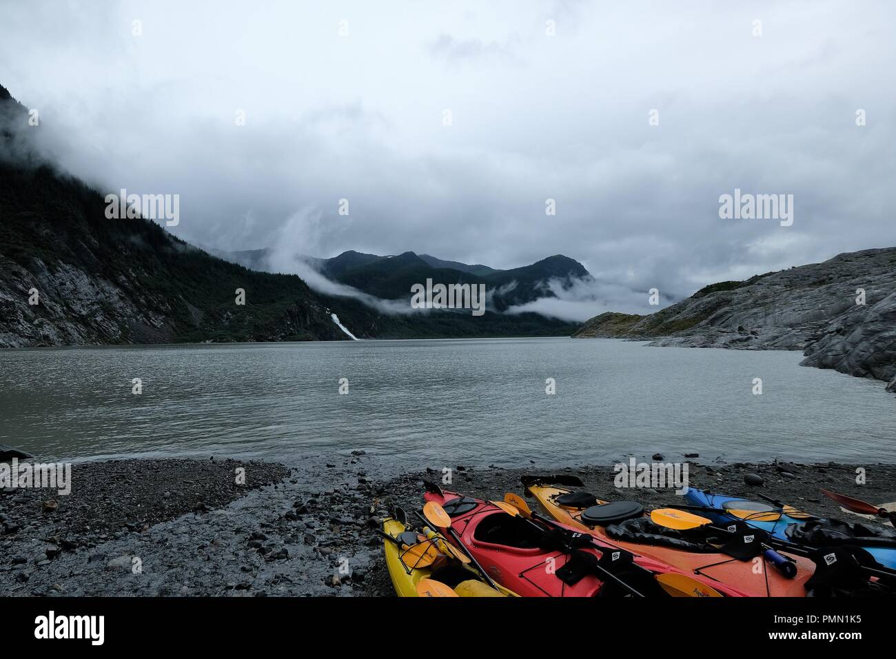 Kayaks waiting for patrons at the edge of Mendenhall Glacier Stock Photo