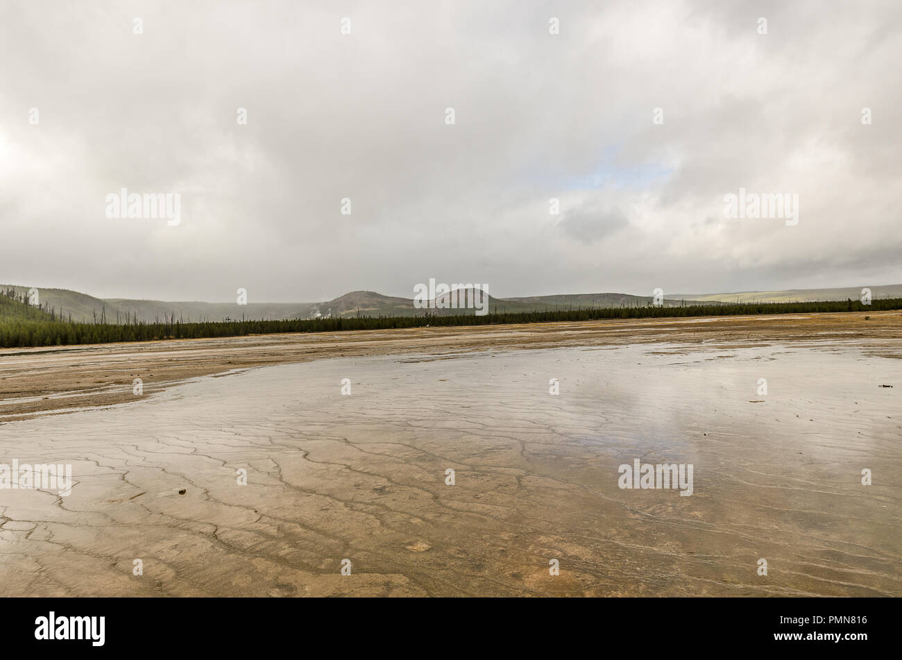 Patch of blue sky reflecting in the water at Midway Geyser Basin on an overcast, perfect day in Yellowstone Stock Photo