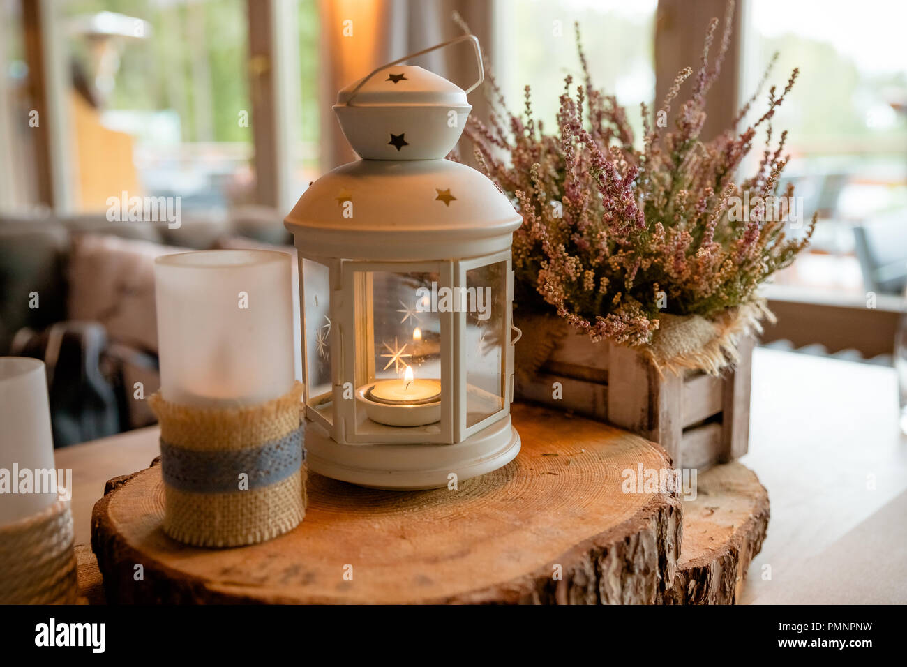 White Lantern With Burning Candle Inside It Standing On Festive
