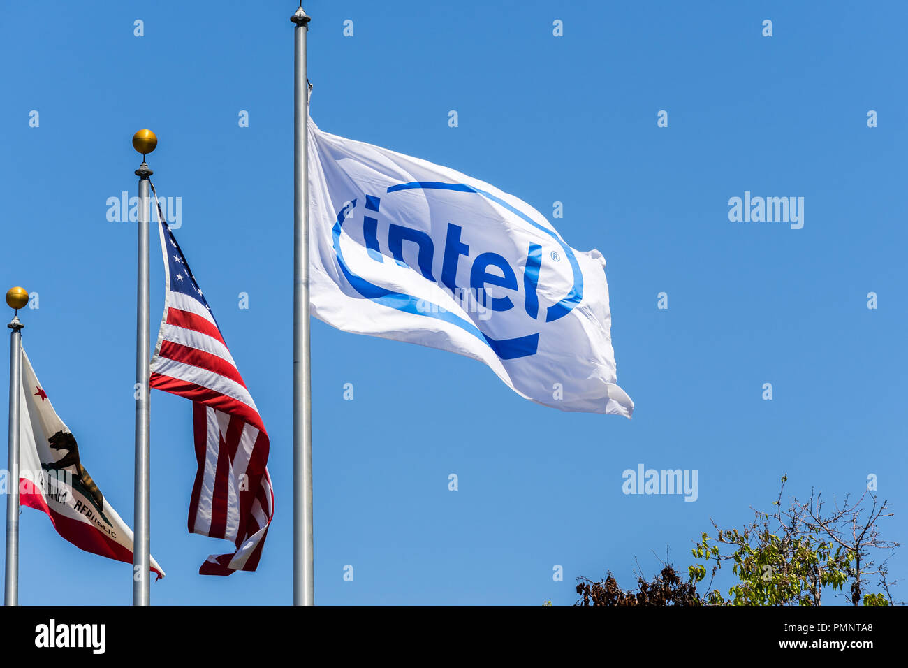 May 3, 2018 Santa Clara / CA / USA - Intel logo on a flag blowing in the wind; The California Republic and the US flag in the background Stock Photo