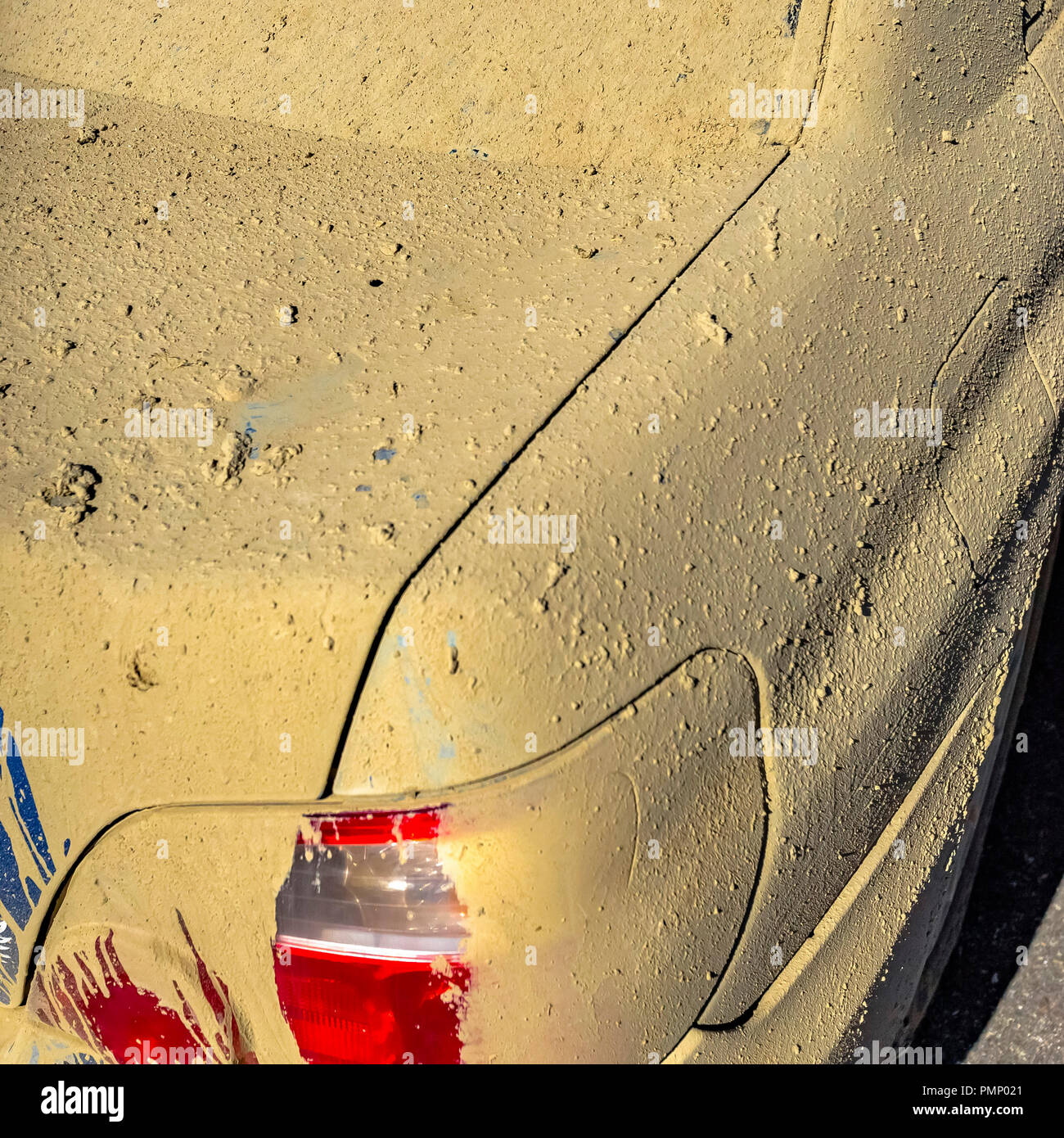 Blue car with red taillight covered in mud Stock Photo Alamy