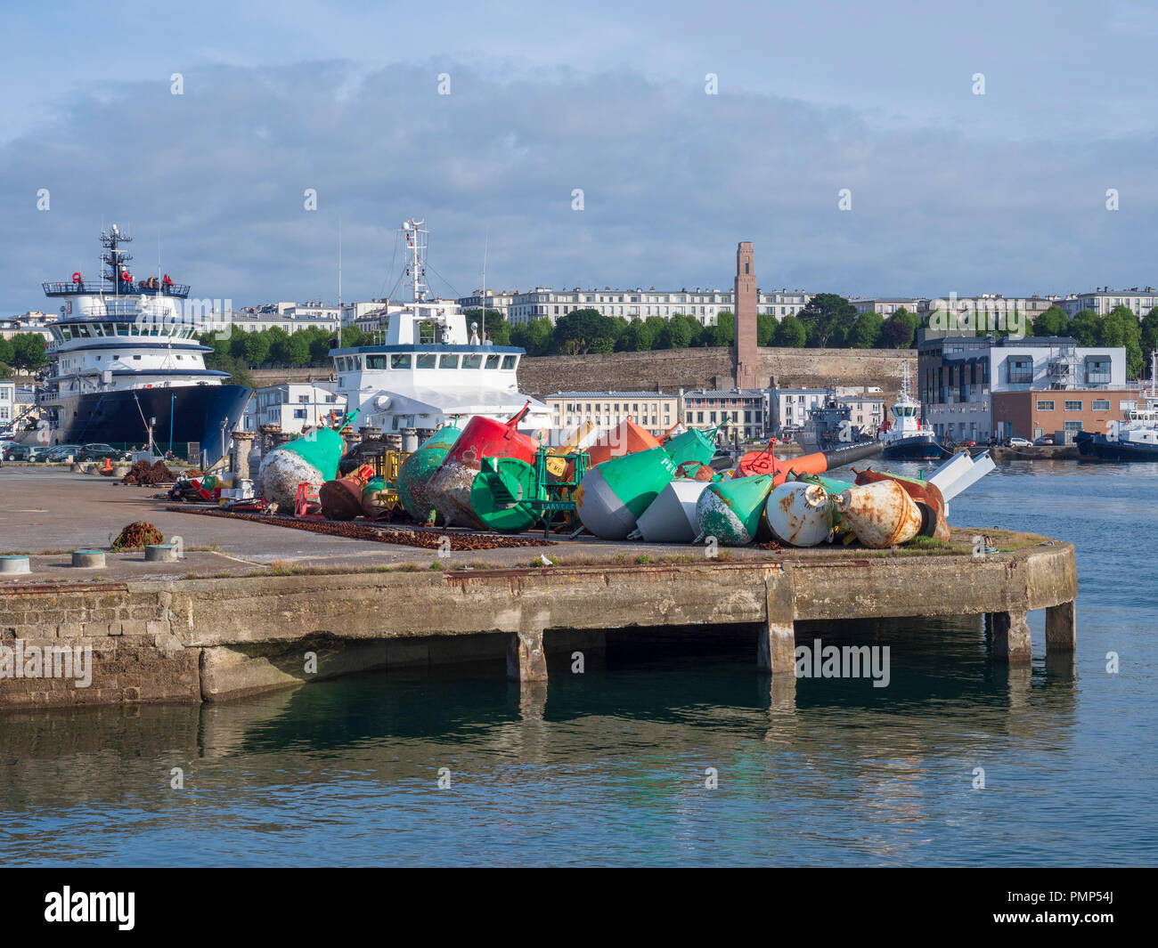 Heap of buoys in front of the building of subdivision of lighthouses and beacons of Brest. Stock Photo