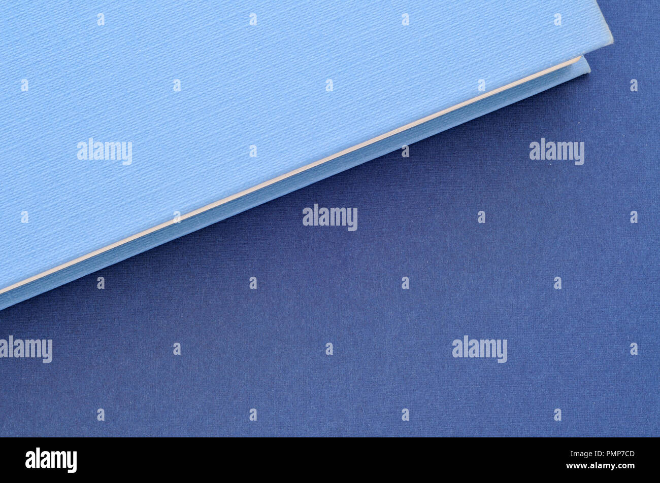 back to school,close up on blue book covers, from above, minimal background Stock Photo