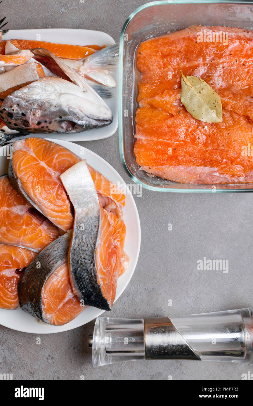 trout or salmon fish splitting on grey table, salted fillet, filler