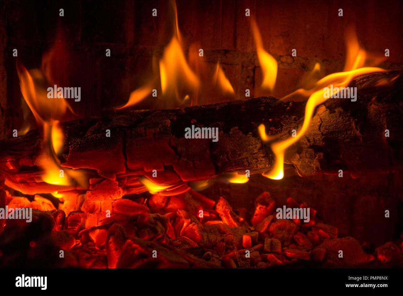 Burning log coal in the fireplace background Stock Photo Alamy