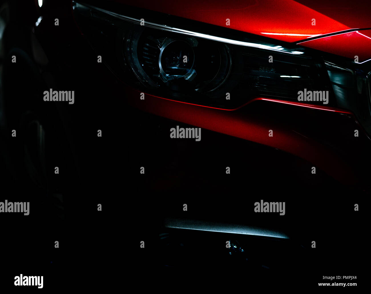 https://c8.alamy.com/comp/PMPJX4/closeup-headlight-of-shiny-red-luxury-suv-compact-car-elegant-electric-car-technology-and-business-concept-hybrid-auto-and-automotive-concept-car-p-PMPJX4.jpg