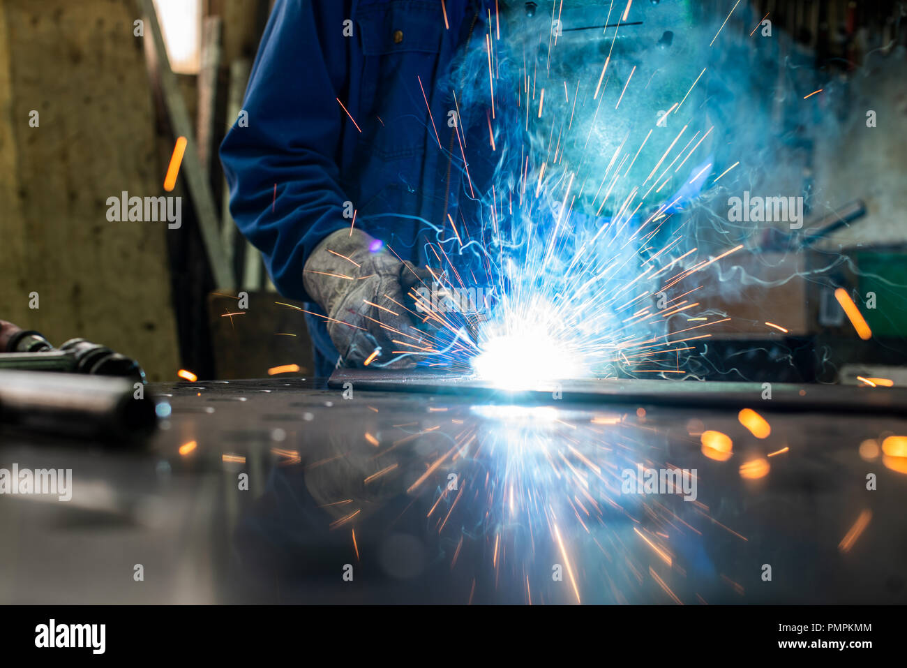Welder in his workshop welding metal Stock Photo